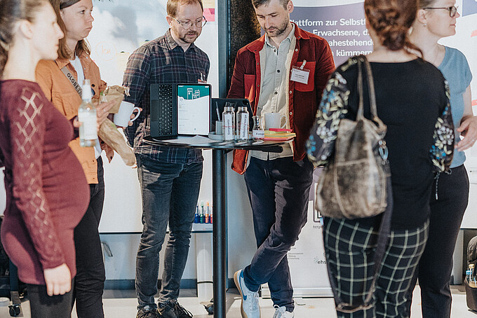 Several people are talking at a bar table