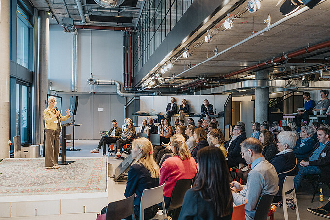 A speaker addressing a large audience